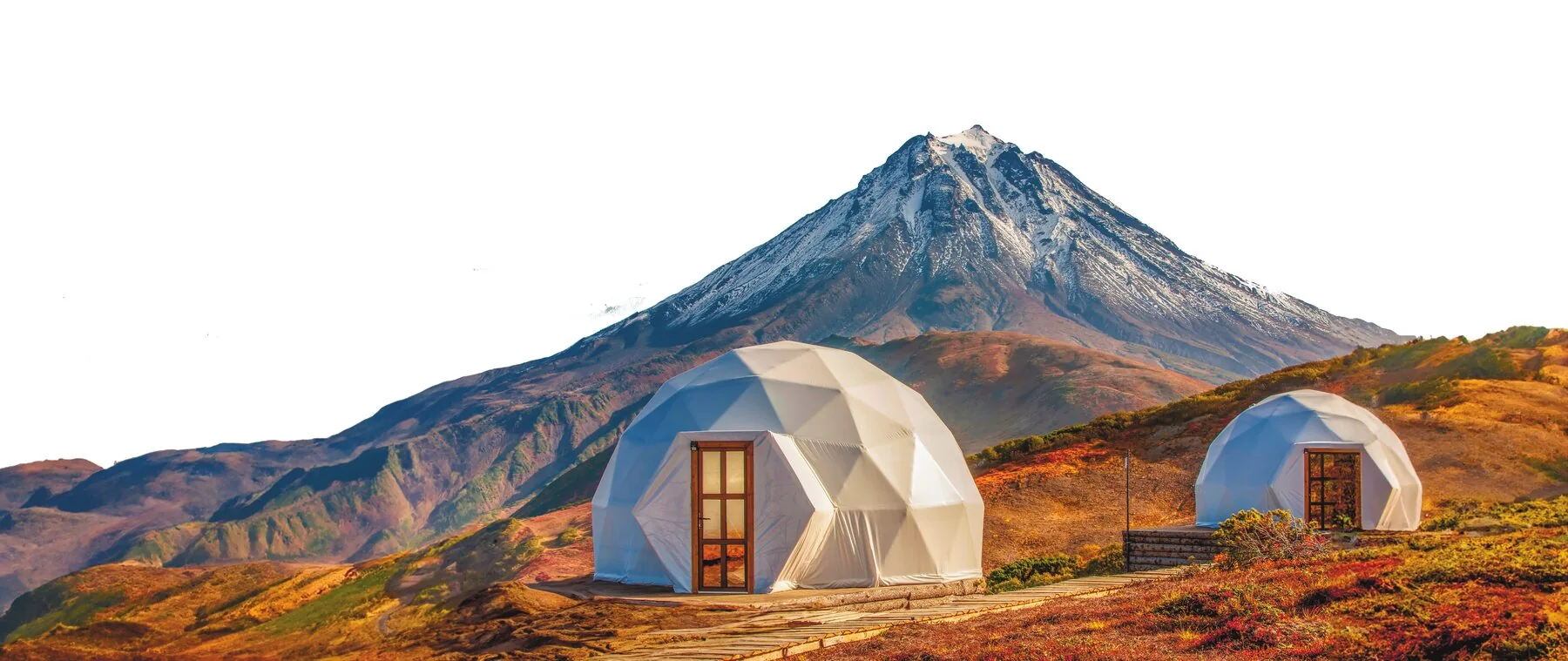 Geodesic domes against a volcanic mountain landscape
