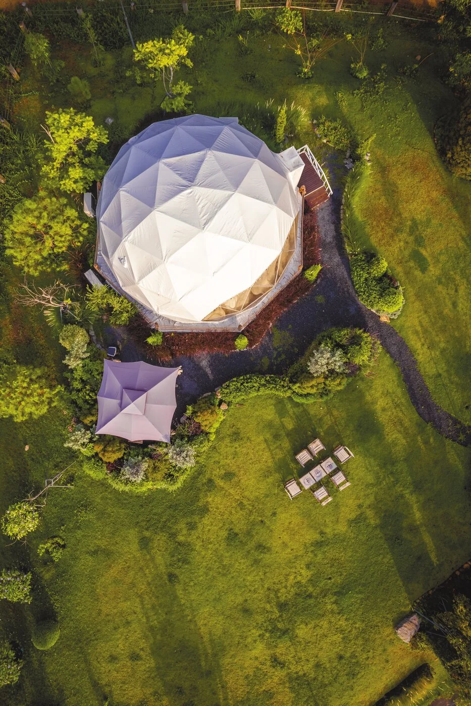 Glamping dome in a green garden setting, Poland